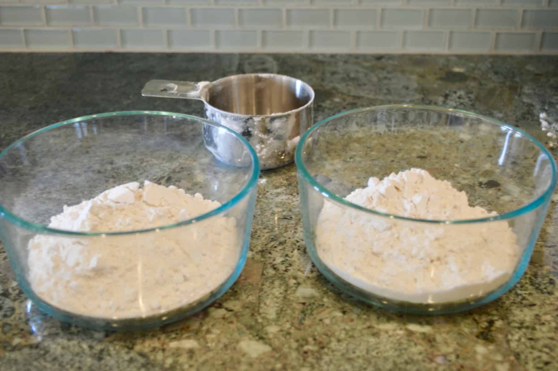 two bowls with flour on a counter 