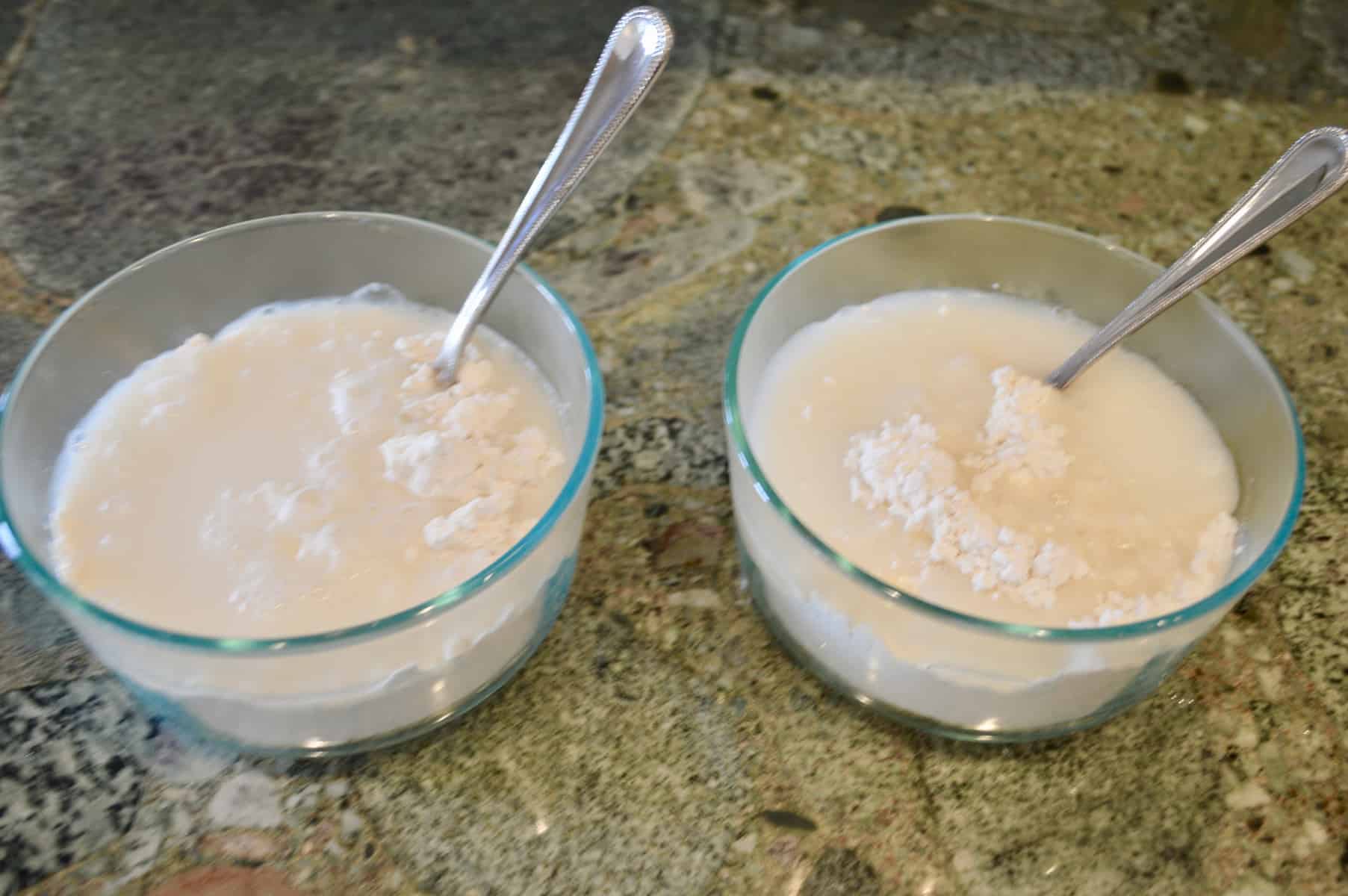 two bowls of water and flour on a countertop 