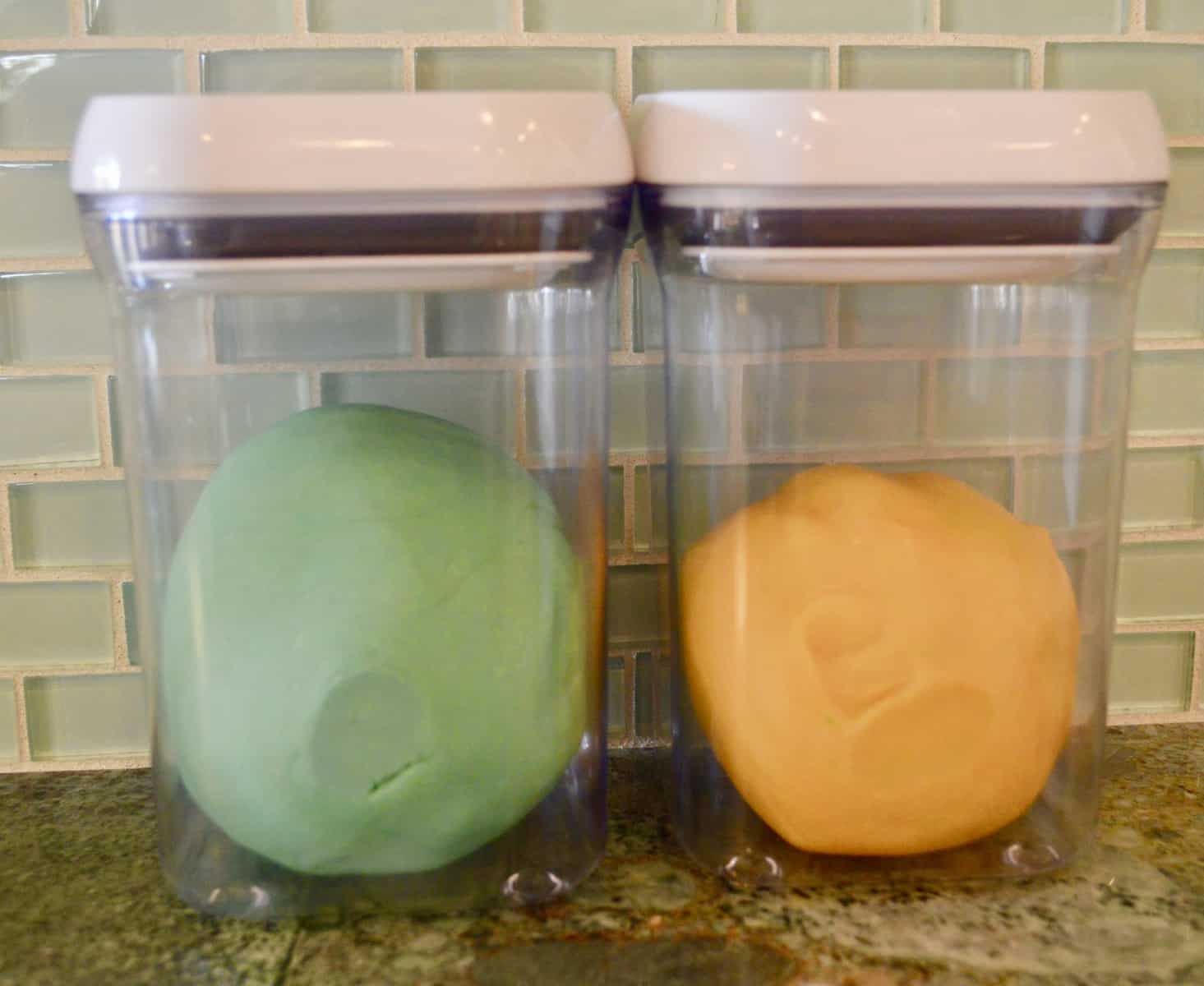 teal and orange play doh in a two airtight containers 