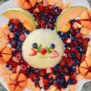 Funny Bunny Fruit Platter makes it ok to play with your food! Kids and adults will love this cute bunny fruit platter. #easter #fruitplatter #brunch #breakfast #cantaloupe #berries #kids #parenting