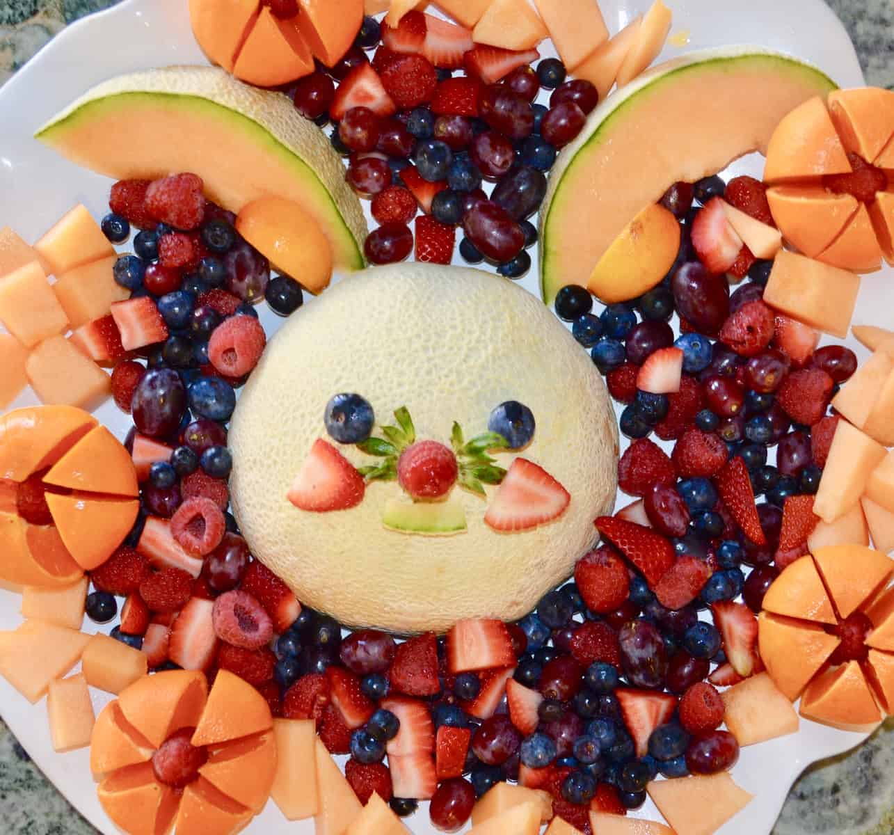 Fruit platter arranged to look like a bunny on a white platter