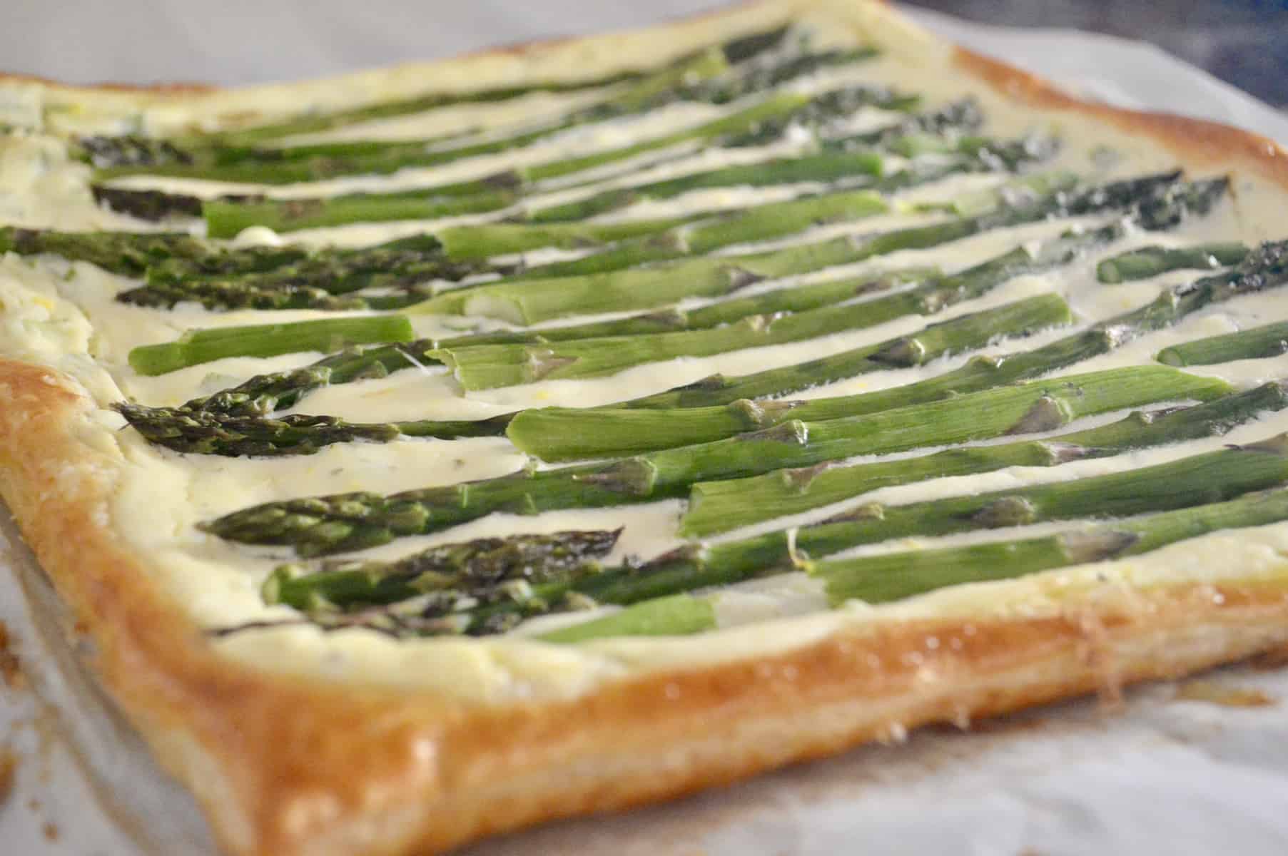 Asparagus Tart with Ricotta and Lemon is made with puff pastry and is an easy recipe for an appetizer or side dish. Best Brunch Recipes. Great party food for baby or bridal showers, or served on the holidays. #asparagus #tart #ricotta #puffpastry #thanksgivingsidedish #christmassidedish #easter #appetizer #partyfood #appetizerforparty #easyrecipe #brunch #breakfast