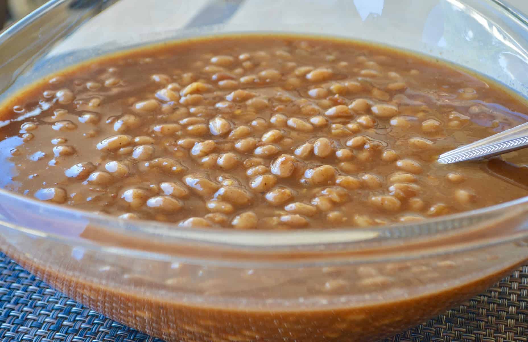 Budget BBQ Baked Beans. Budget BBQ Recipes and tips that are easy and fun! Host a barbecue and save money. Includes hamburgers, hot dogs, corn, chips, beans, watermelon and drinks! #budgetbbq #barbeque #grilling #grillingrecipes #bbqrecipes #easybbq #budgetfood #budgetrecipes