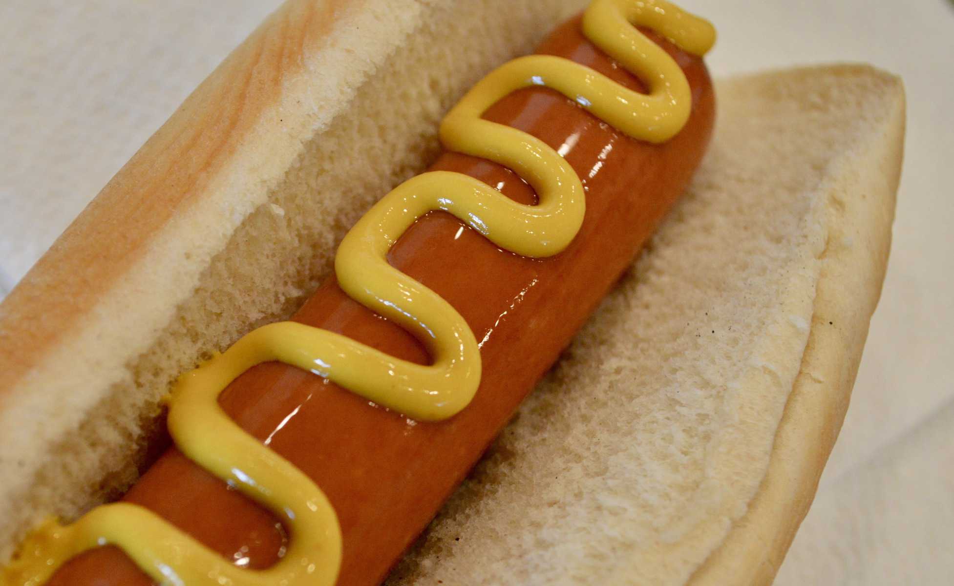 hot dog with yellow mustard on it. 