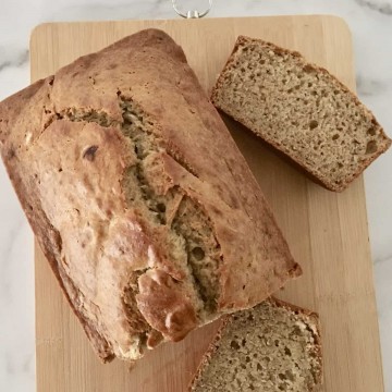 Eggless Banana Bread on a wooden cutting board.