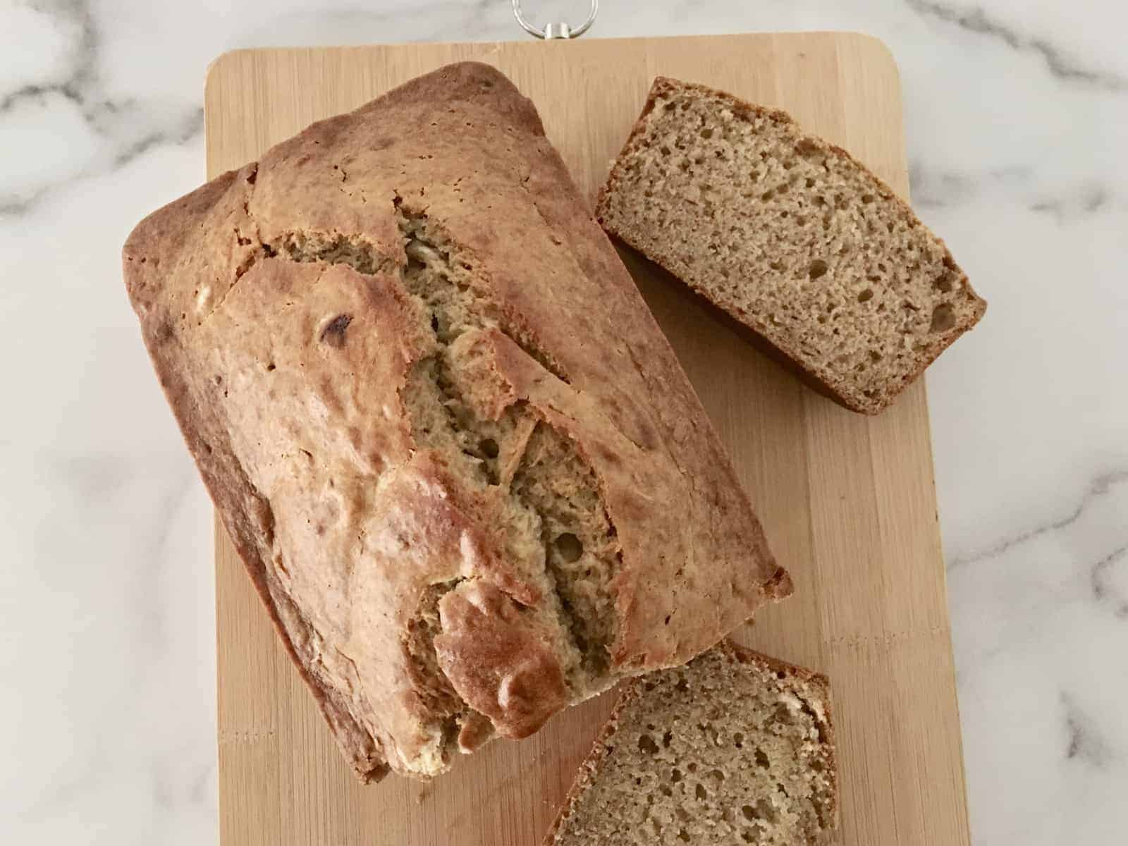 Eggless Banana Bread on a wooden cutting board. 