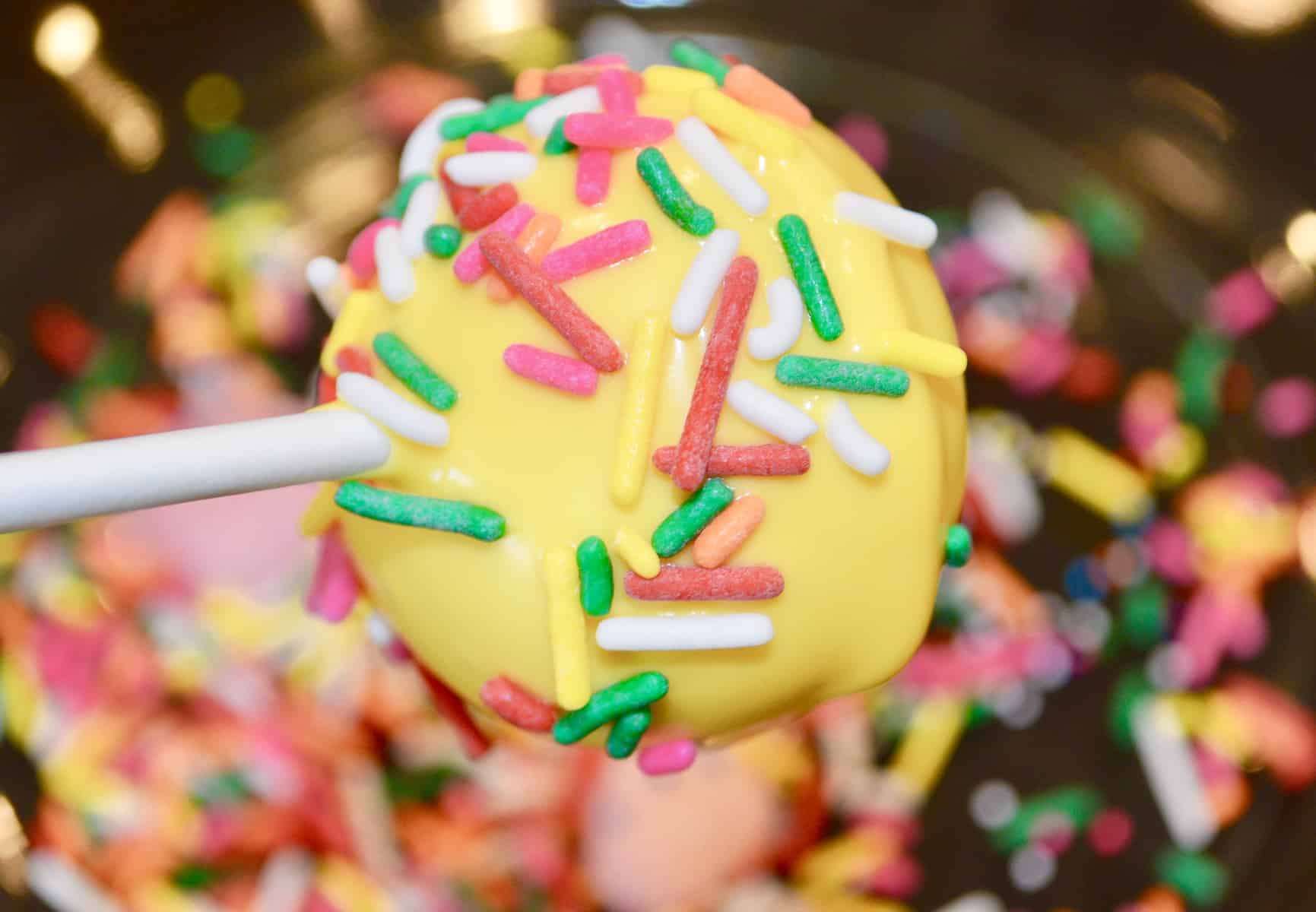 sprinkles covering the yellow cake pop. 