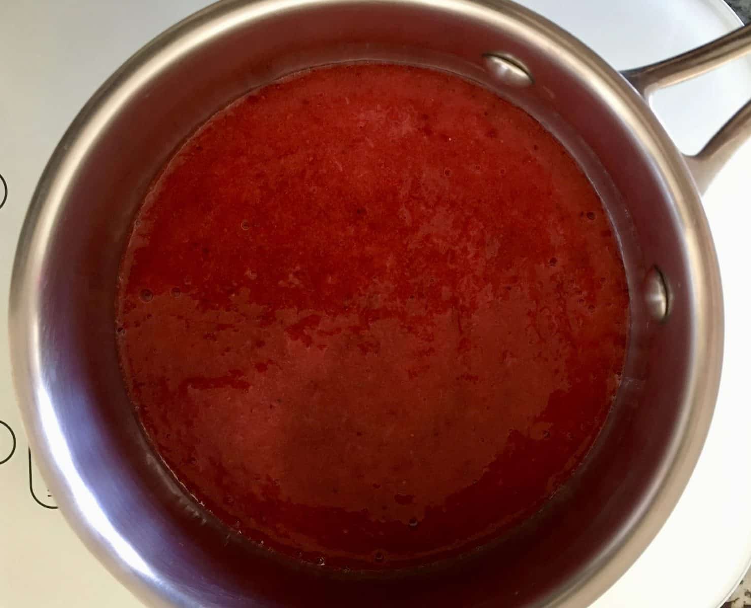 pureed strawberries in a small saucepan. 