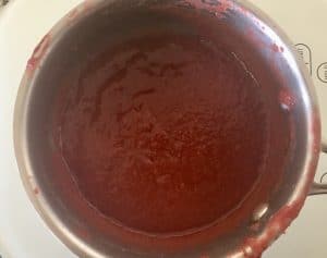reduced strawberry concentrate in a small saucepan