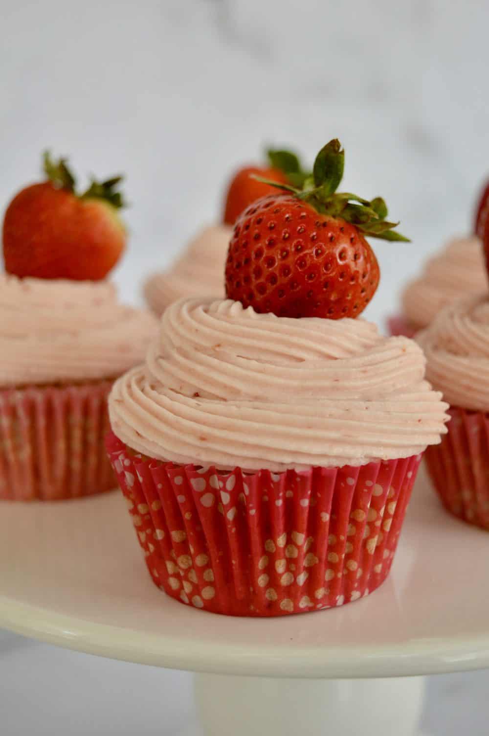Strawberry Cupcake on a white pedestal. 