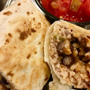 Freezer Burritos with ground turkey, brown rice, black beans, and cheddar cheese is an easy recipe for make ahead burritos that you freeze. Healthy and full of protein, these are a great weeknight dinner or meal prep food. #freezerfoods #freezerburritos #burritos #makeahead #mealprep #groundturkey #healthy #parenting #protein #easyrecipe #weeknightdinner #blackbeans