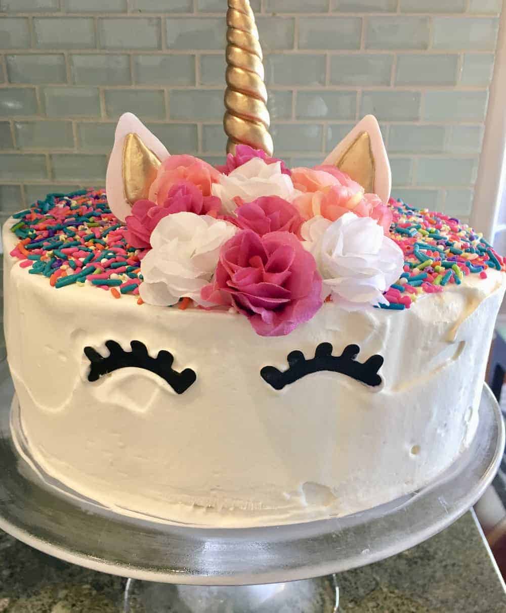 unicorn ice cream cake on a pedestal. 