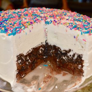 Unicorn Ice Cream Cake is an easy recipe that is a copycat of Dairy Queen. This recipe is homemade using whatever ice-cream you want, Oreos, fudge sauce, and sprinkles. #icecreamcake #dairyqueen #copycat #easy #recipe #homemade #unicornbirthdayparty #unicorn #birthdayparty #birthdaycake #oreos #sprinkles #fudge #parenting #kids #stepbystep
