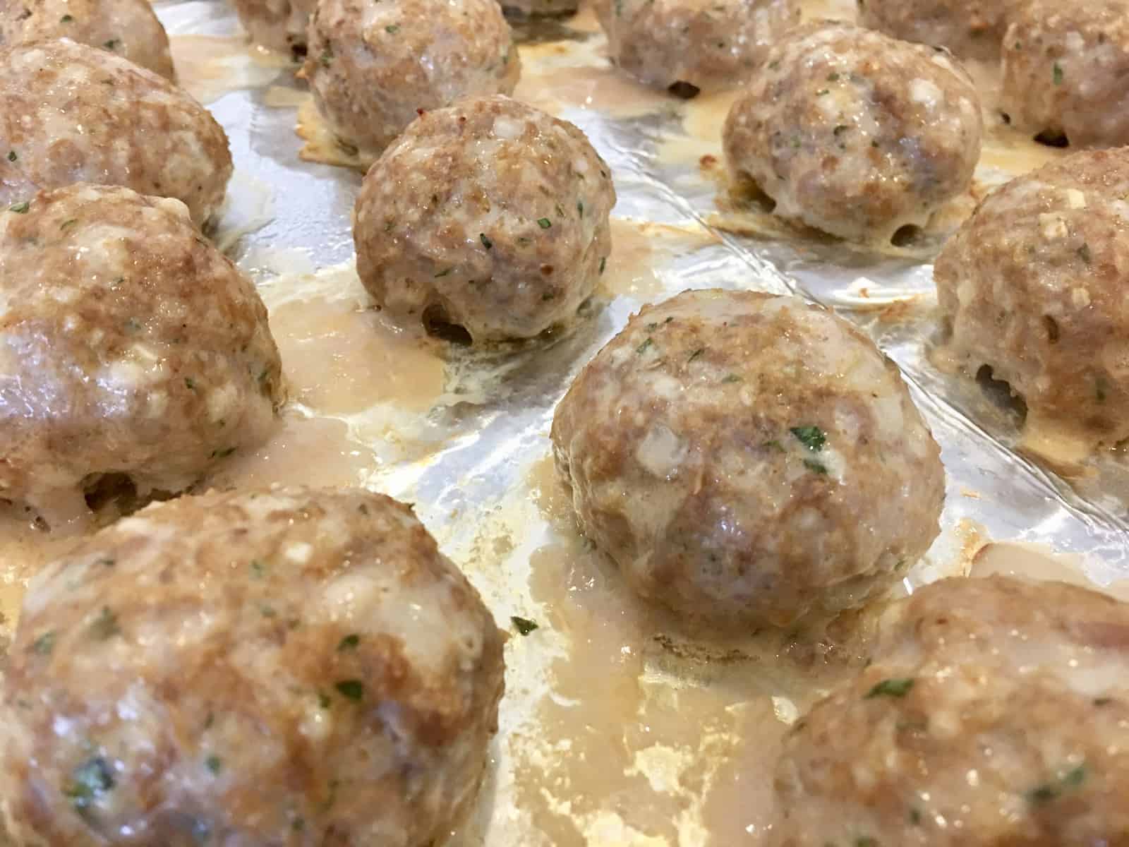 meatballs on a foil lined baking sheet. 