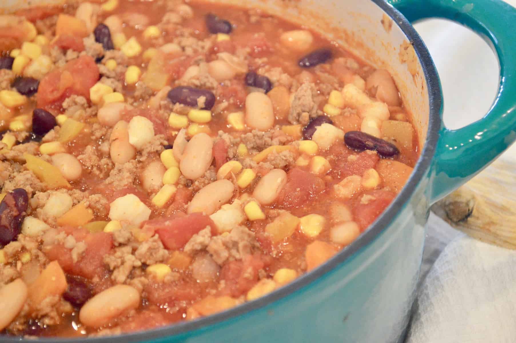 Healthy Turkey Chili with Hominy and Beans in a Teal Pot