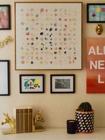 Gallery Wall Using Kids Artwork. How to set up a gallery wall and incorporate your kids artwork. A mix of canvas, framed, and metal decor add to this gallery wall. Great way to showcase your kids artwork! #kidsartwork #gallerywall #kidsideas #kids #art #fungallerywall #eclectic #easygallerywall #simple #stepbystepguide #art #wallart