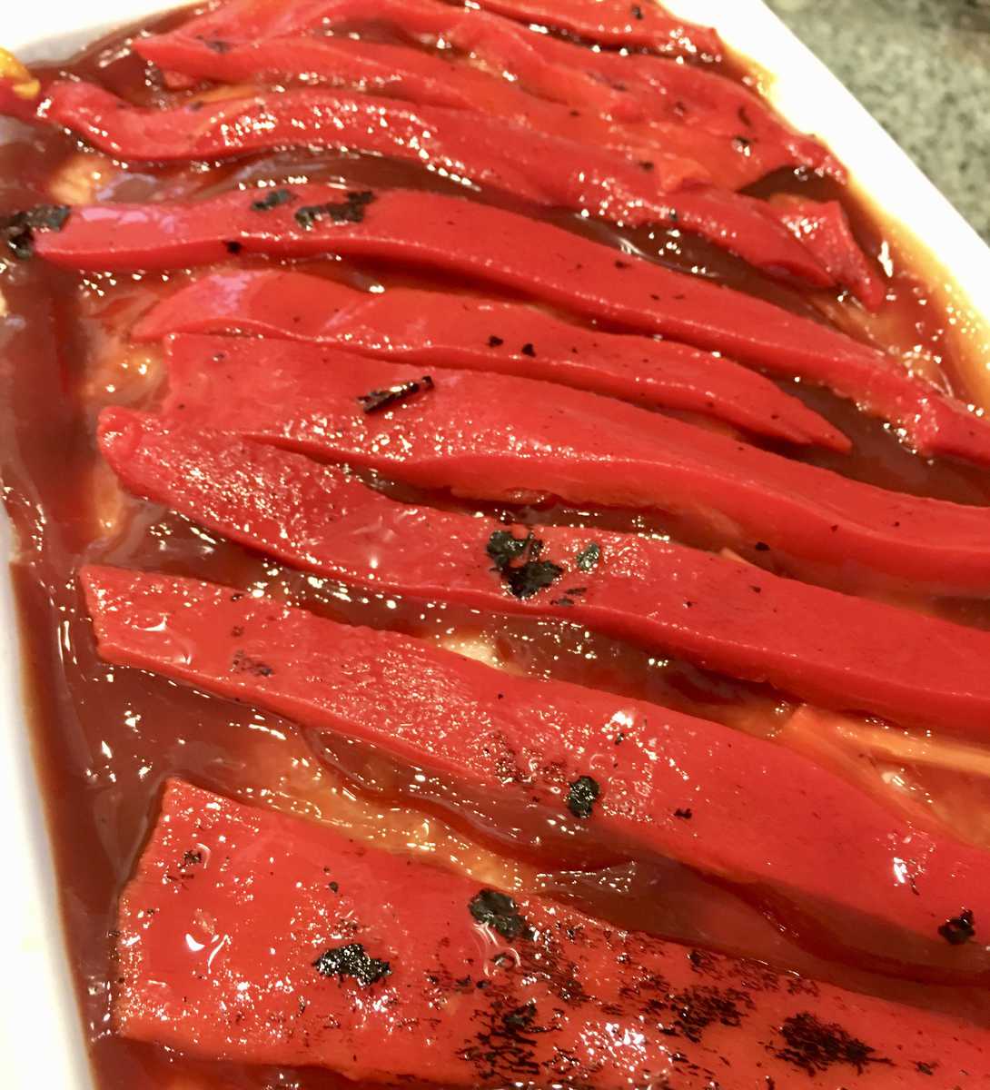 layered strips of bell peppers on top of the meat. 