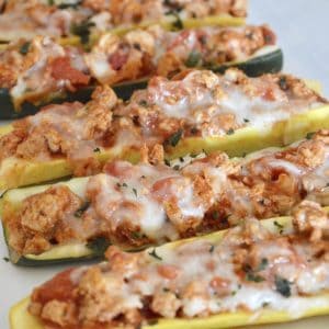 Healthy, low-carb, low-calorie and so easy to make, don't miss these delicious Stuffed Zucchini Boats with Yellow Squash filled with lean ground turkey and tasty Italian flavors.  #weeknightdinner #easyrecipe #healthy #lowcarb #lowcalorie #parenting #zucchini #stuffedzucchini #yellowsquash #groundturkey #healthyitalian