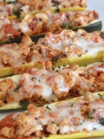 Healthy, low-carb, low-calorie and so easy to make, don't miss these delicious Stuffed Zucchini Boats with Yellow Squash filled with lean ground turkey and tasty Italian flavors.  #weeknightdinner #easyrecipe #healthy #lowcarb #lowcalorie #parenting #zucchini #stuffedzucchini #yellowsquash #groundturkey #healthyitalian