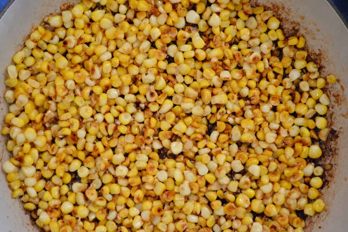 Photo of the corn kernels being charred in a large skillet. 