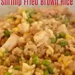 Shrimp Fried Brown Rice with peas and corn in a large white serving bowl