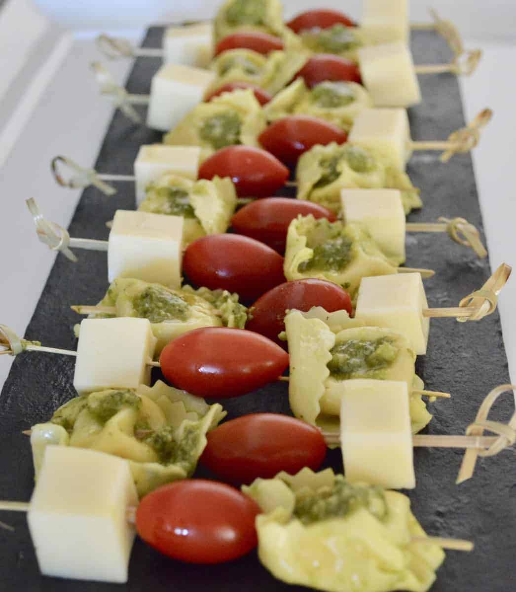 pesto tortellini skewers with provolone and cherry tomatoes 