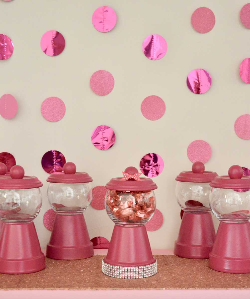 DIY Gumball Machine Party Favors set up on a pink table with pink backdrop