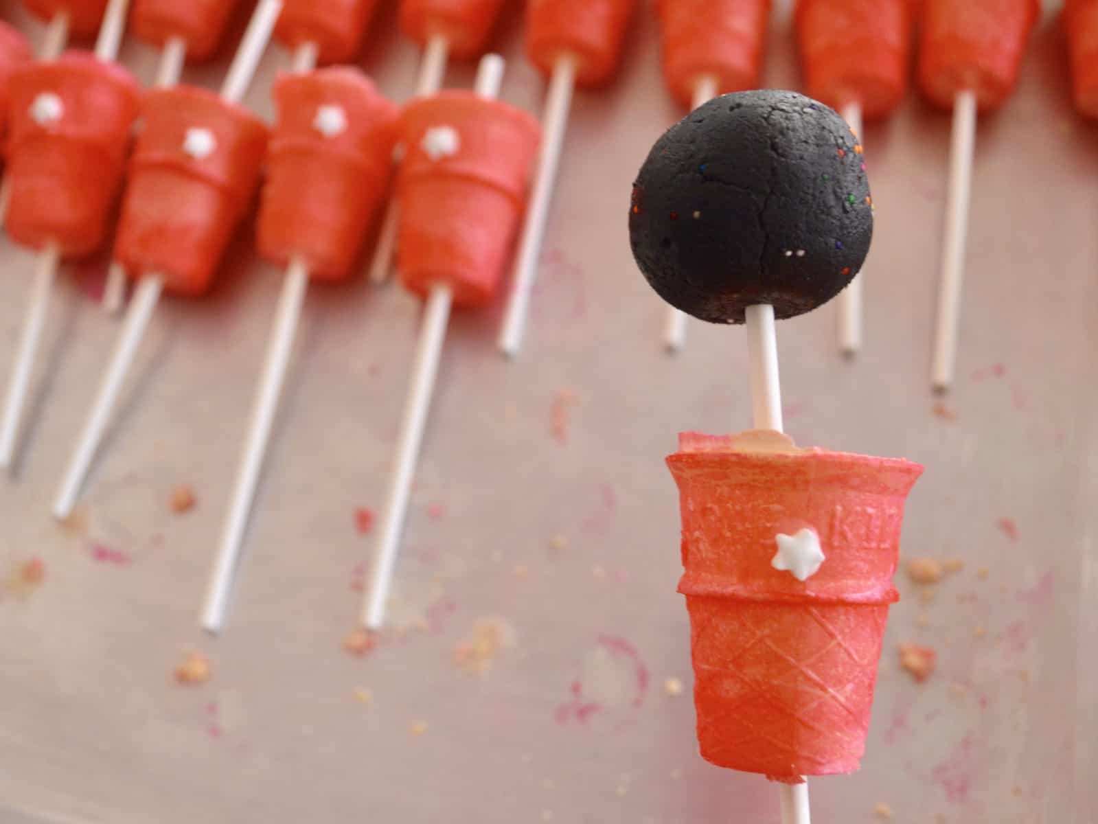 Microphone cake pops adding the oreo ball to the stick of the pops