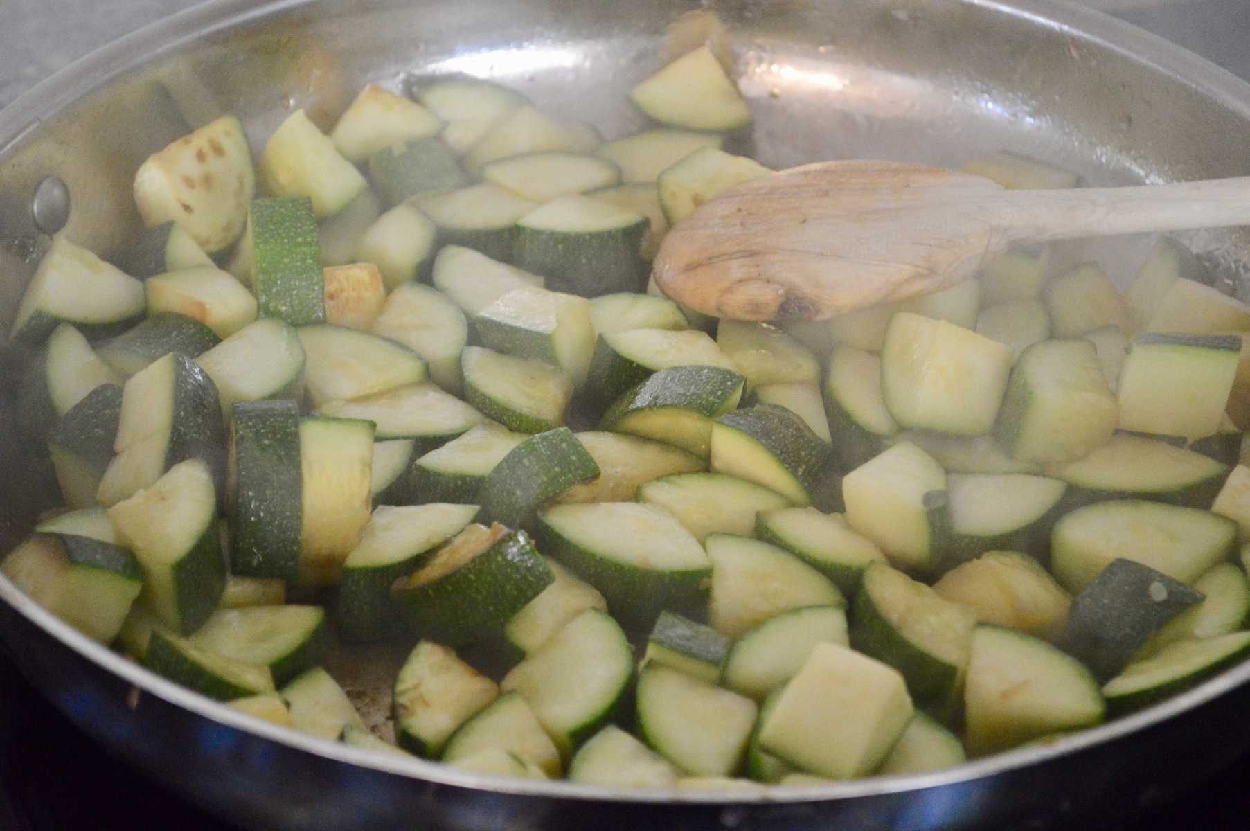 zucchini sautéing in a pan