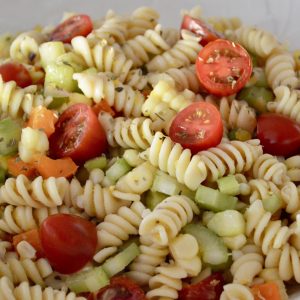 Pasta Salad with Veggies and Corn in a white bowl