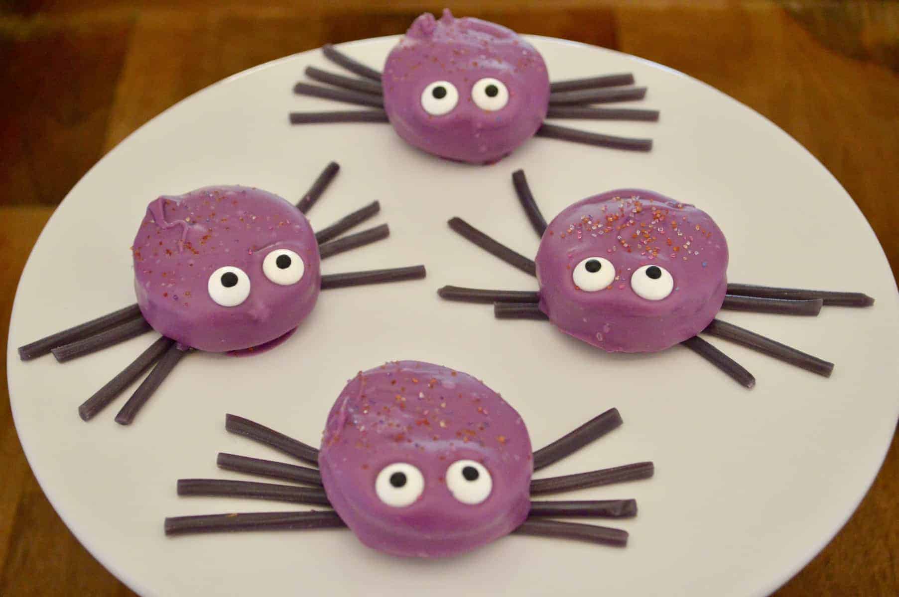 oreo cookie spiders on a white pedestal