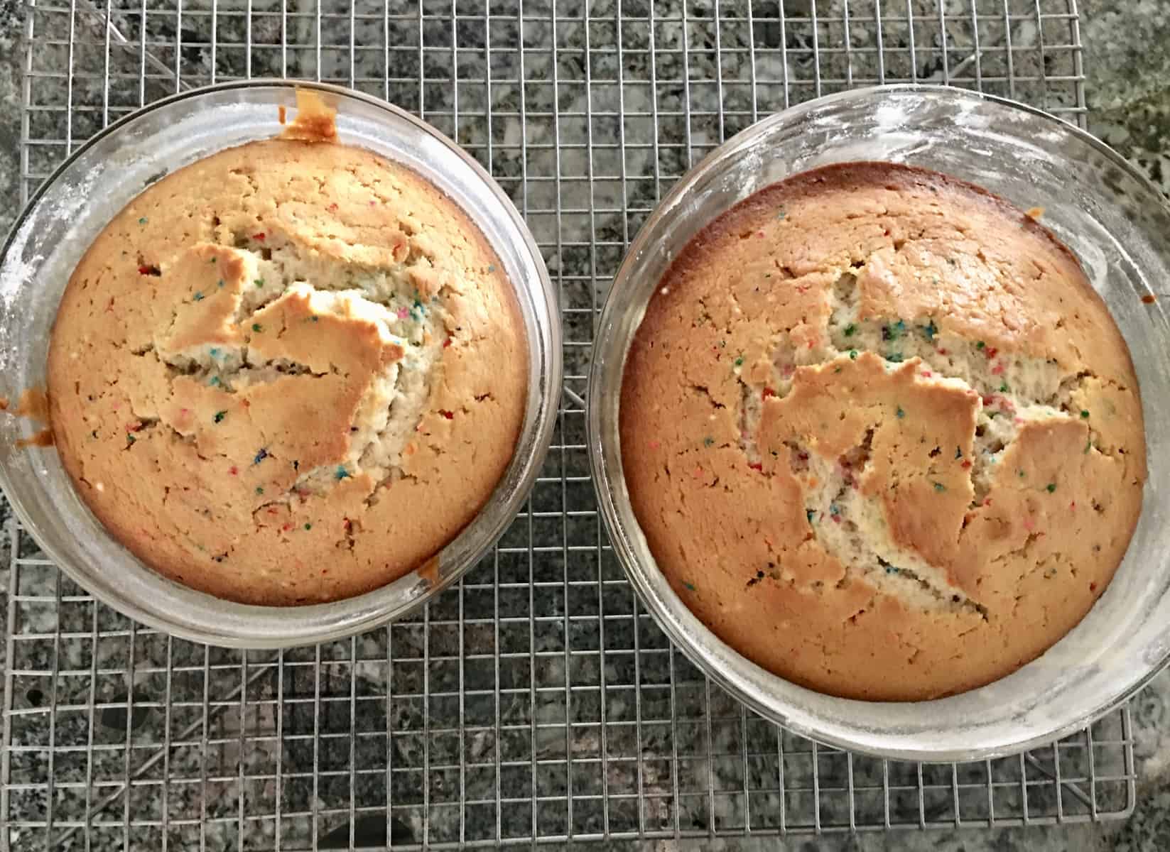 two glass bowls on a wire rack with cooked batter. 