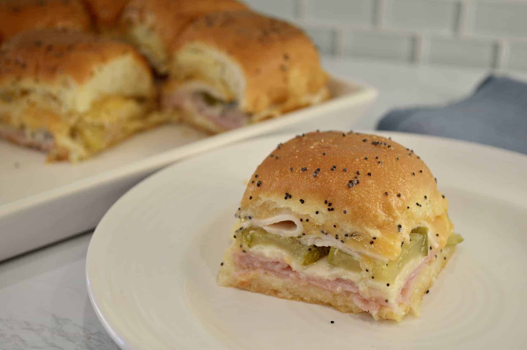 ham and cheese sliders on a white plate 