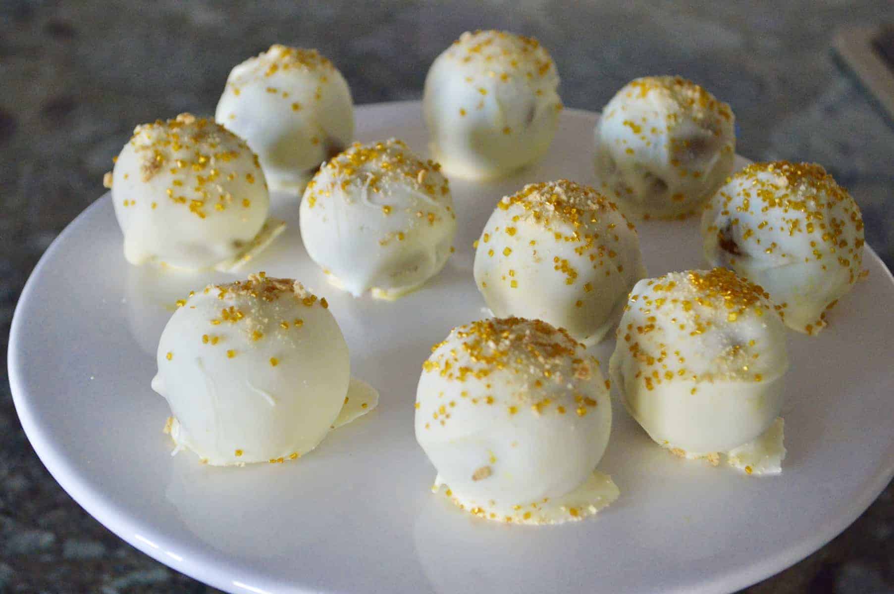 pumpkin spice truffles on a white platter with gold sprinkles 