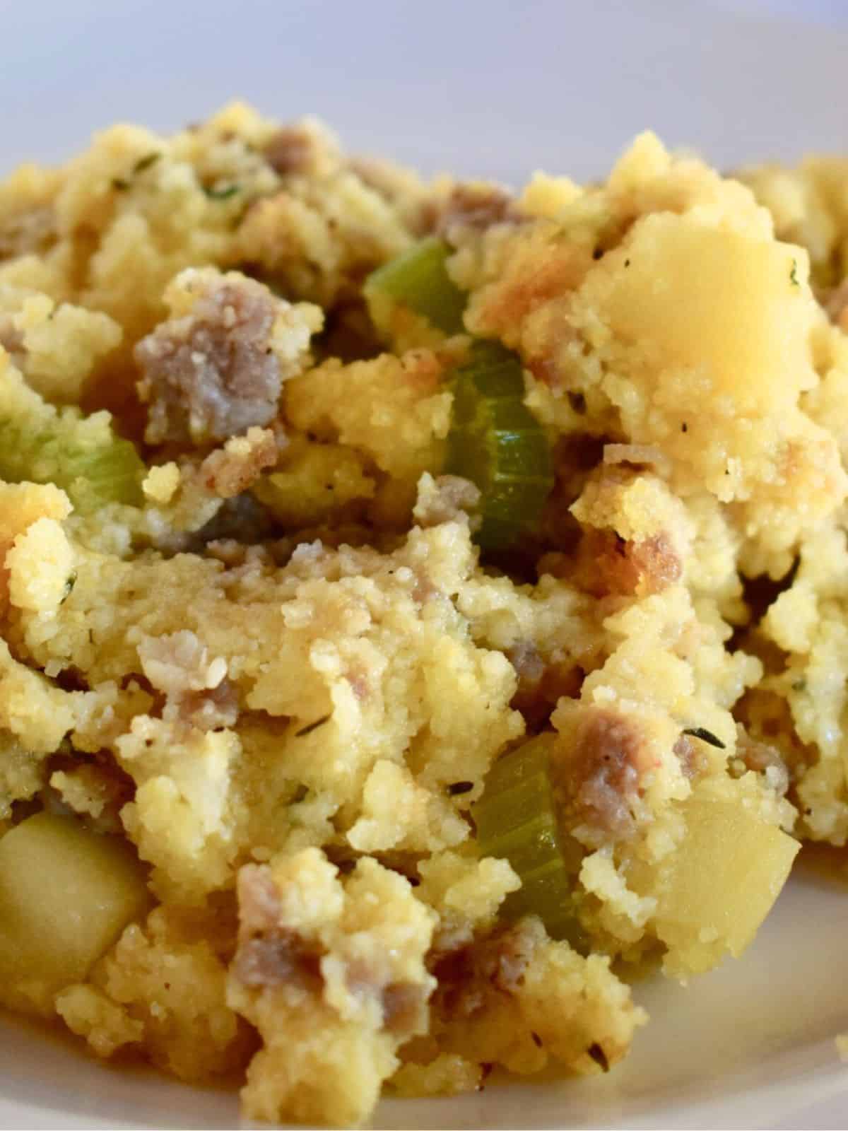 Cornbread Stuffing with Sausage and apples on a white plate. 