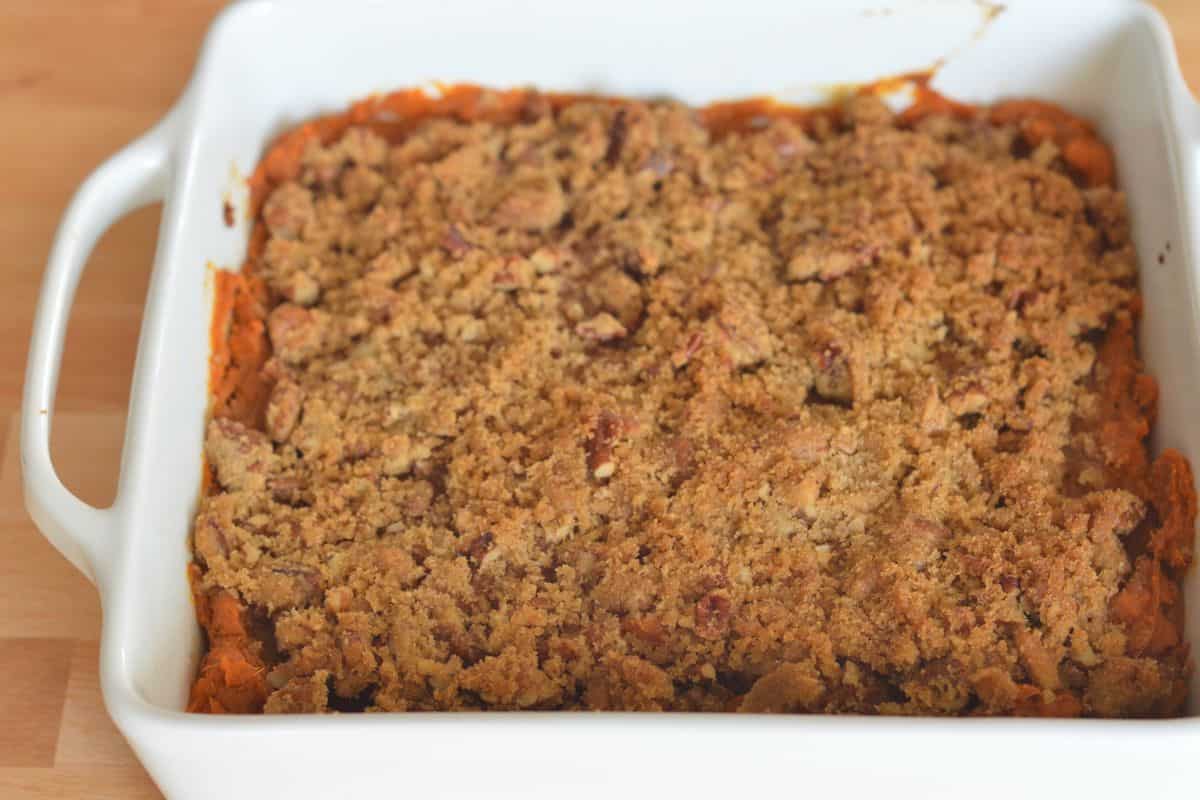 Sweet Potato Casserole with Pecan Streusel Topping in a white casserole dish. 