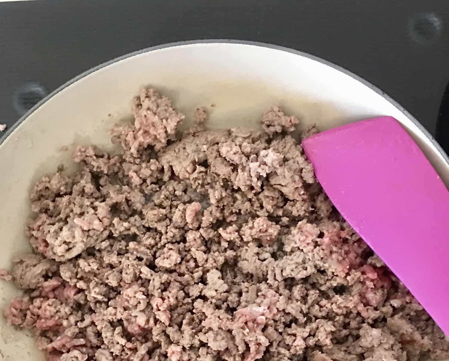 ground beef cooking on stove. 