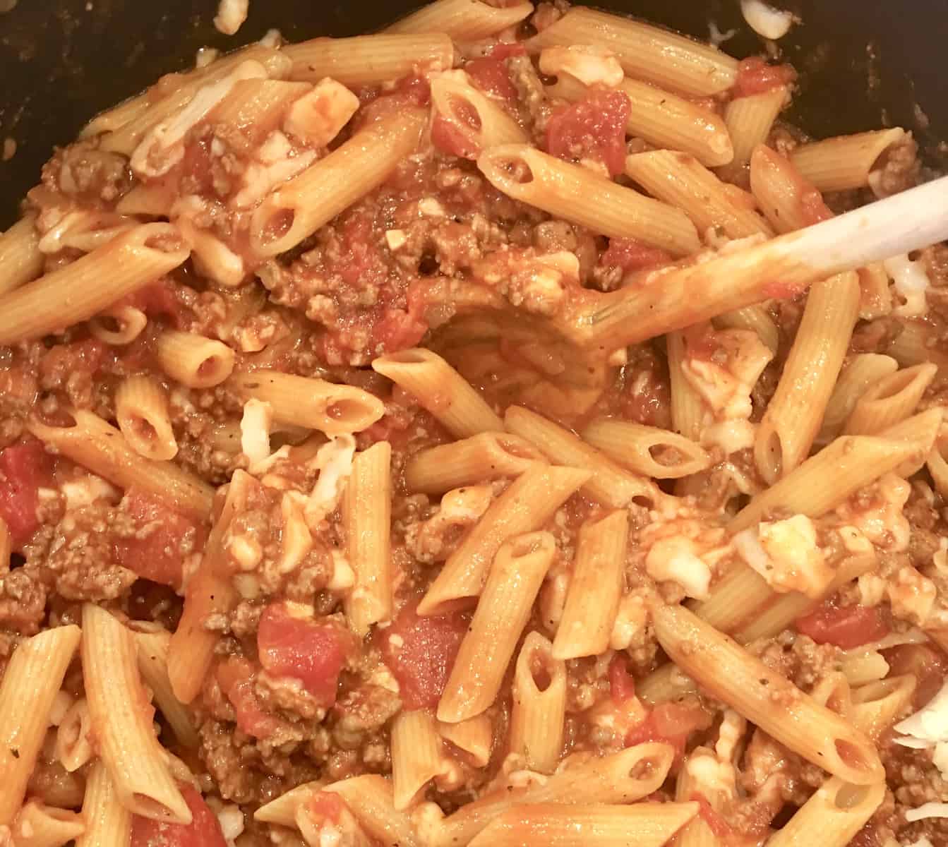 baked ziti with meat sauce in a pot. 