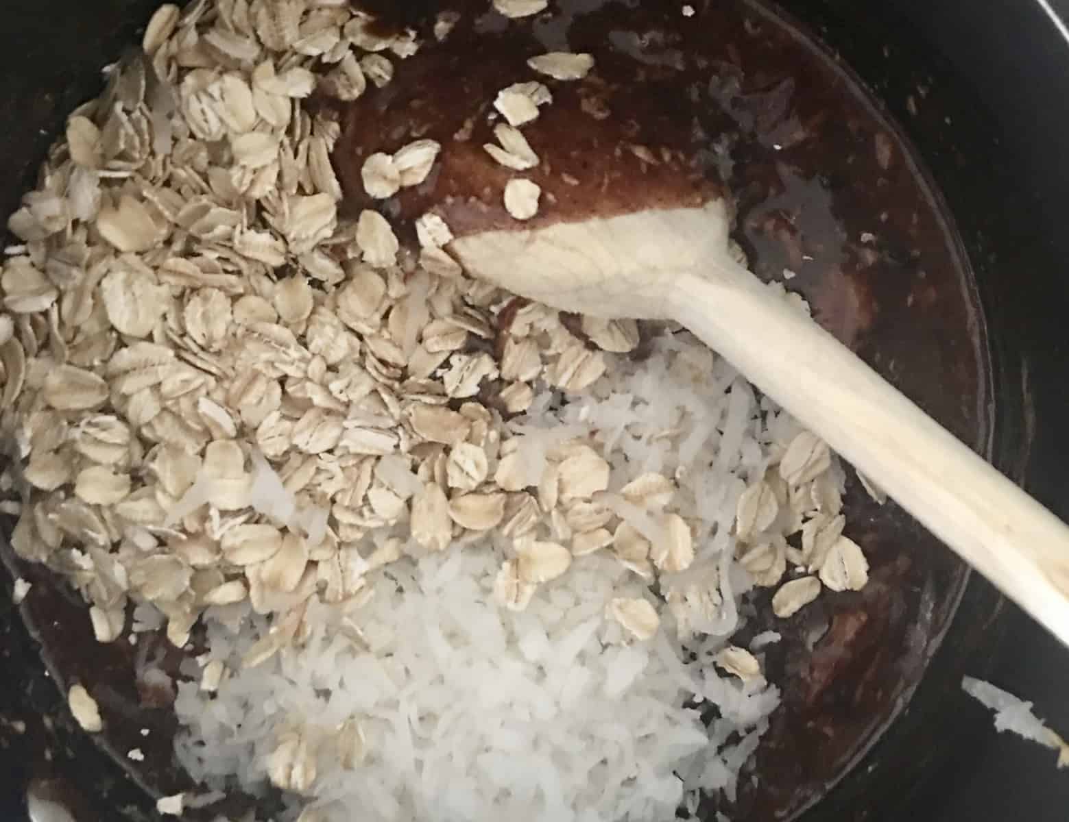 stirring in coconut and rolled oats in the saucepan mixture. 