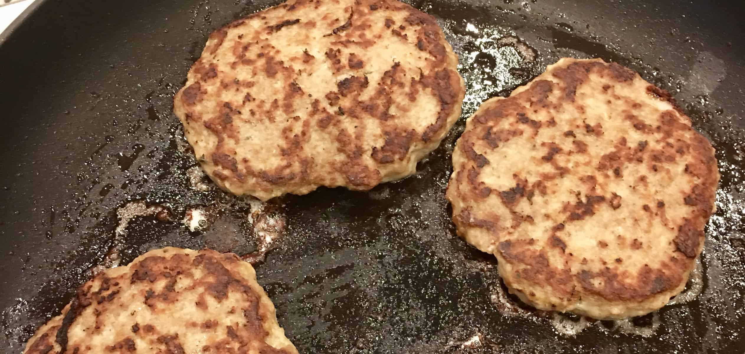 Classic Turkey Burgers on the Stove frying in a frying pan