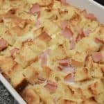eggs benedict casserole just out of the oven in a white baking dish