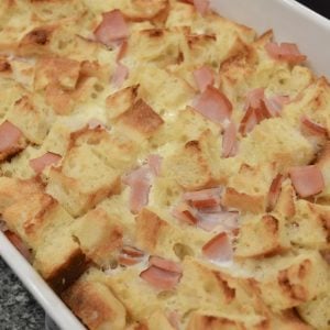 eggs benedict casserole just out of the oven in a white baking dish