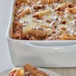 Baked Ziti with meat sauce in a white baking dish.