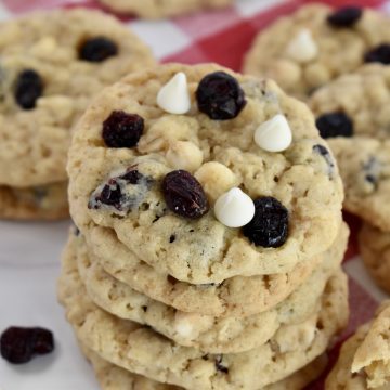 White Chocolate Cranberry Cookies stacked on a plate.