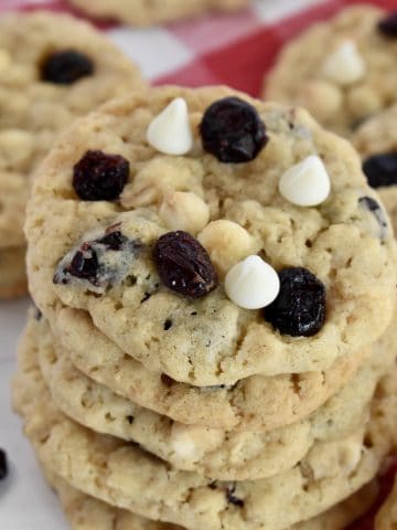 White Chocolate Cranberry Cookies stacked on a plate.