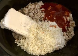 Ingredients in crock pot for buffalo chicken dip