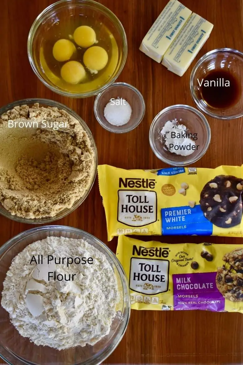 overhead photo of ingredients needed to make recipe including chocolate chips, flour, baking powder, eggs, and vanilla.