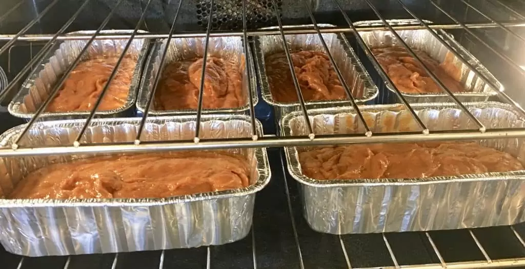 six loaves of bread baking in the oven. 