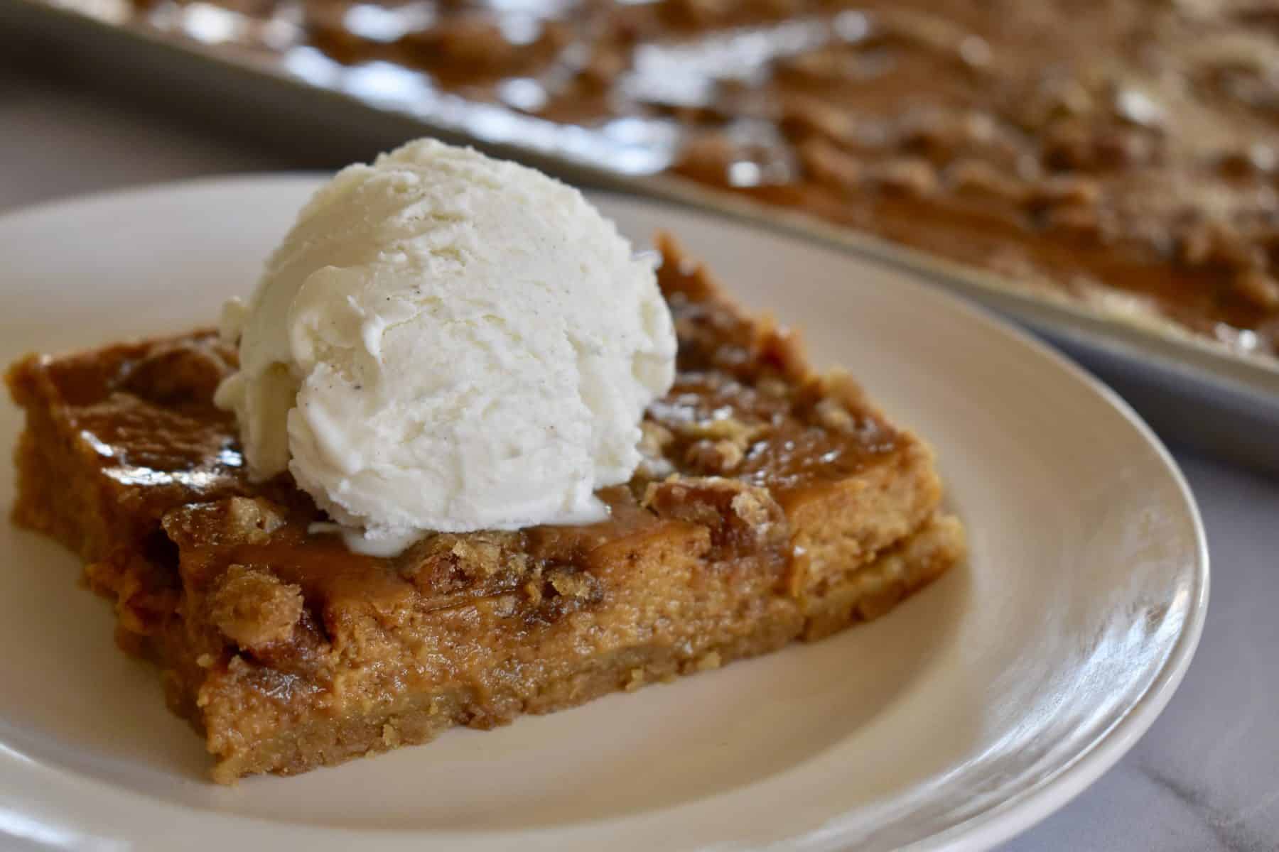 Pumpkin Pie Bars with a scoop of ice cream. 