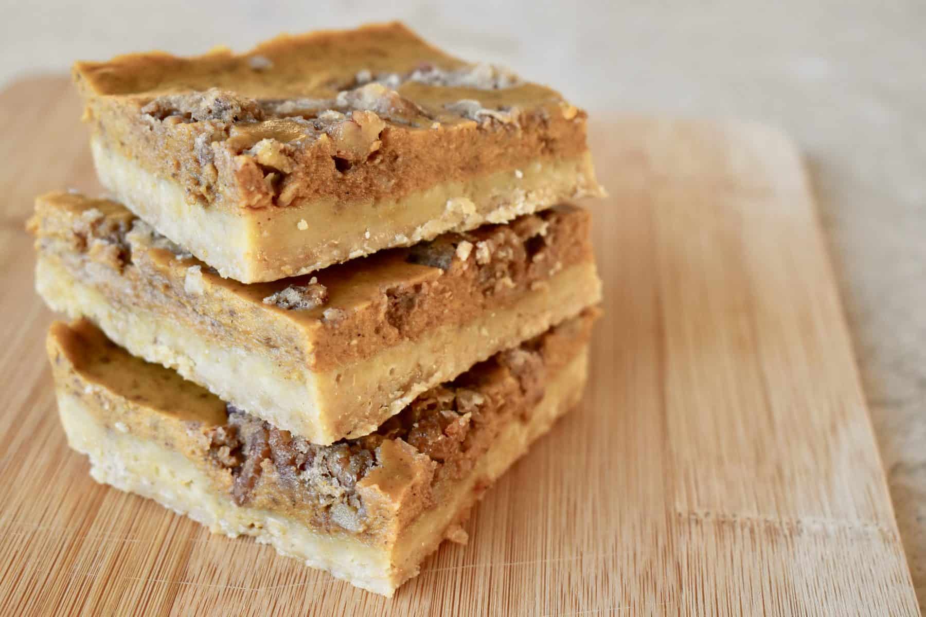 Pumpkin Pie bars piled on a cutting board.